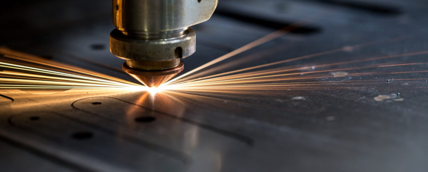 Cutting of metal. Sparks fly from laser